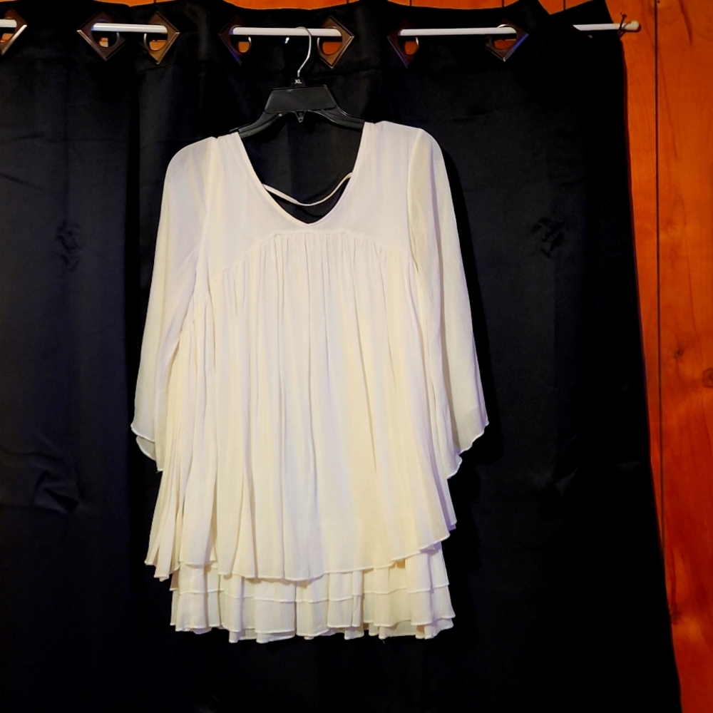 Cream colored nice blouse. Only worn once. No stains or holes.